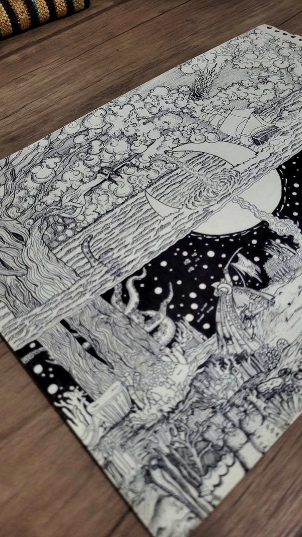 Decorative black and white drawing with intricate patterns on a wooden floor.